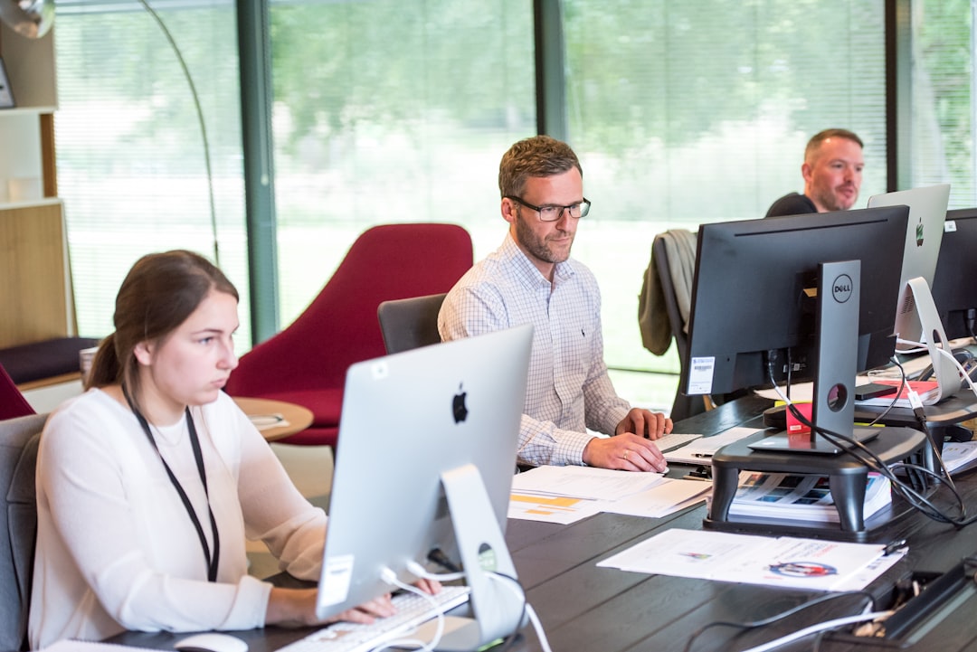 Office workers focused on computer screens